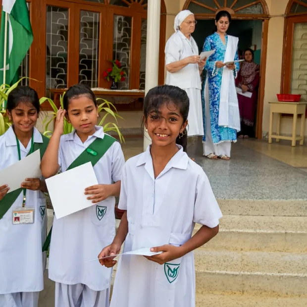 Chanel and her sisters in school uniforms on the school steps